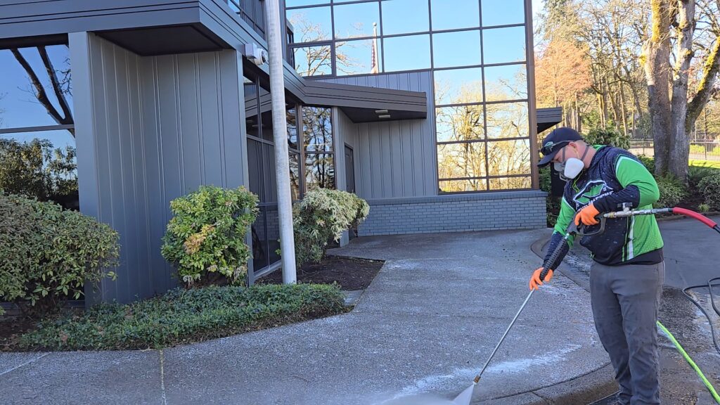 Man pressure washing concrete in Eugene Oregon